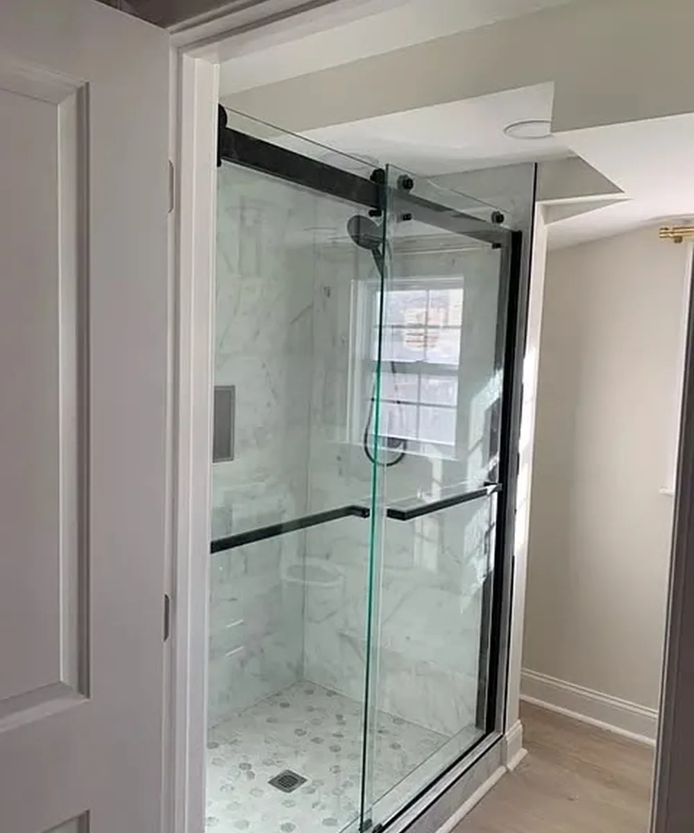 Glass shower enclosure with black hardware