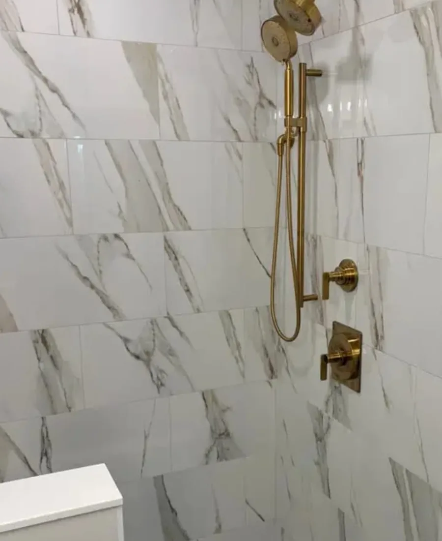 Completed shower remodel with gold fixture